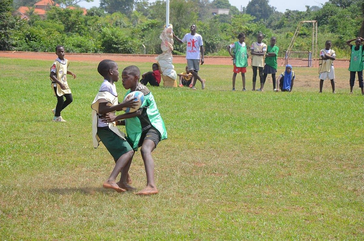 Children playing junior rugby on a training pitch