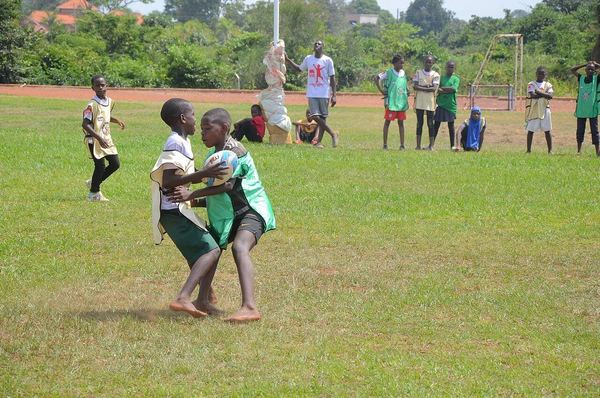 Children playing junior rugby on a training pitch