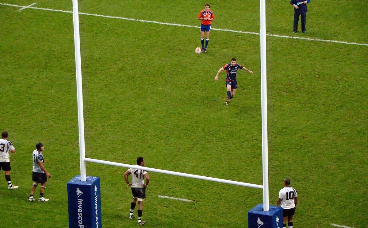 Rugby player kicking a conversion at the posts