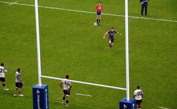Rugby player kicking a conversion at the posts