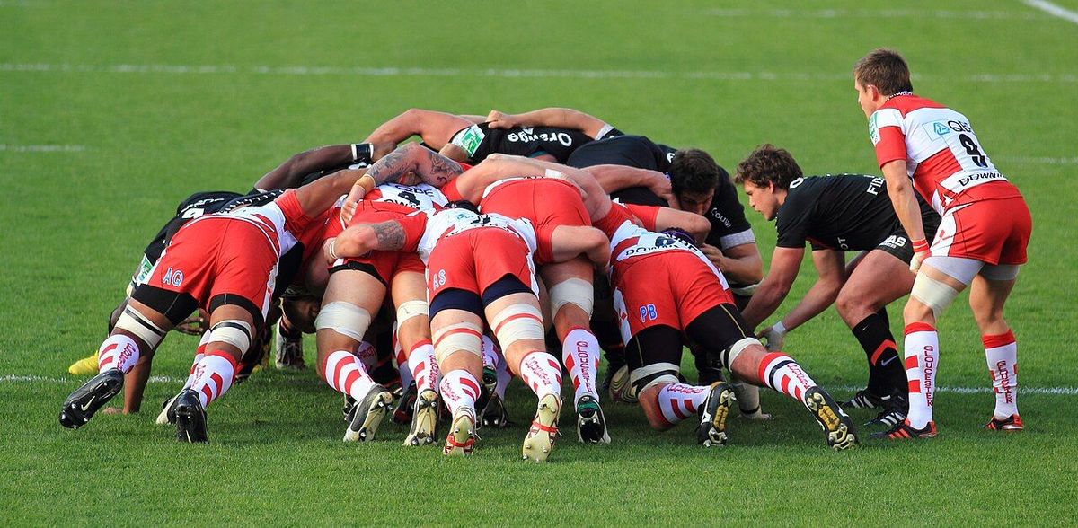 Two rugby front rows bound together in a scrum