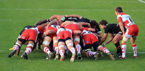 Two rugby front rows bound together in a scrum