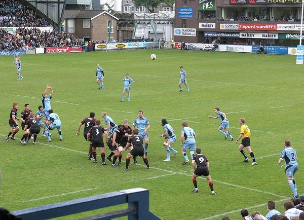 Rugby players in a scrum at a Welsh club match