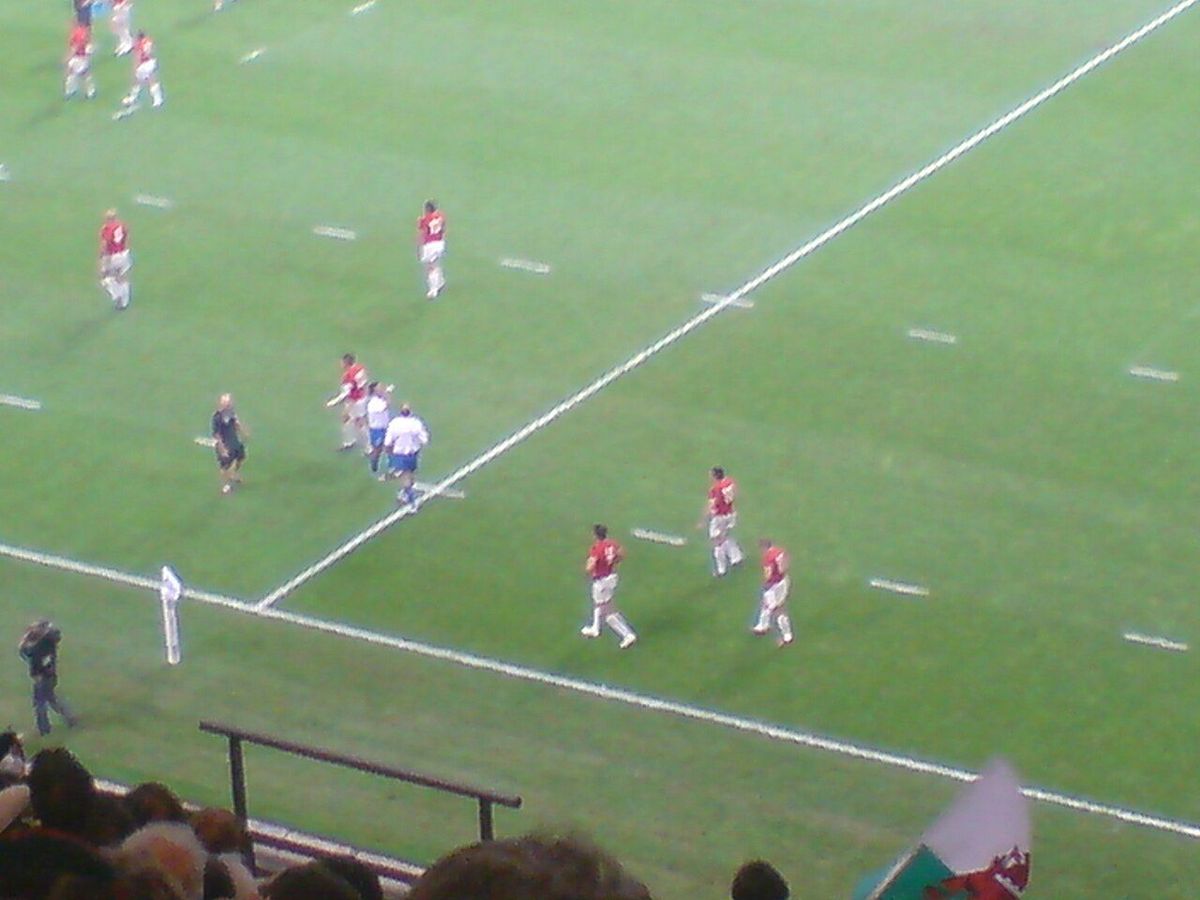 A Wales rugby wing scoring a try in a match