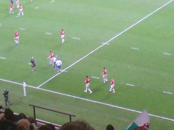 A Wales rugby wing scoring a try in a match
